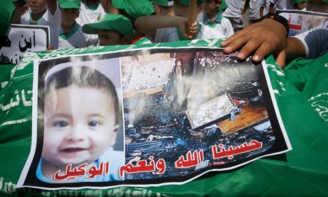 Palestinian children carry a picture of 18-month-old Ali Saad Dawabsha, the toddler who was burned to death by suspected Jewish extremists. Photo: Abed Rahim Khatib / Flash 90